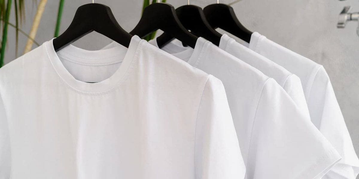 row-of-white-t-shirts-on-hangers-on-rack-2021-09-27-20-29-50-utc