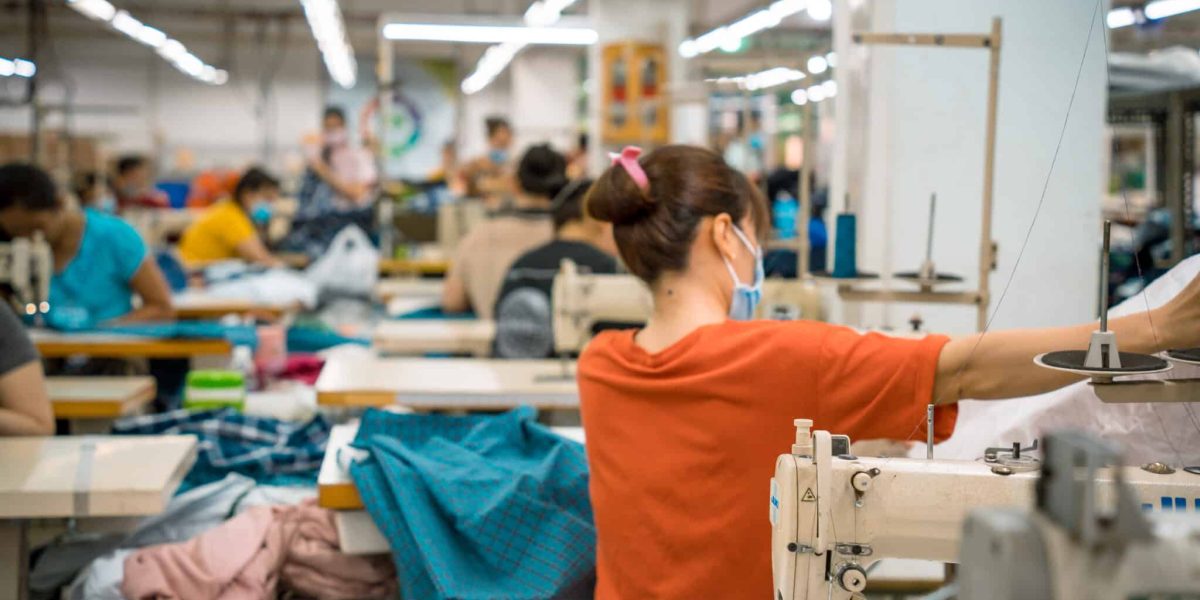 Textile cloth factory working process tailoring workers equipment. This is a sewing machine factory production.